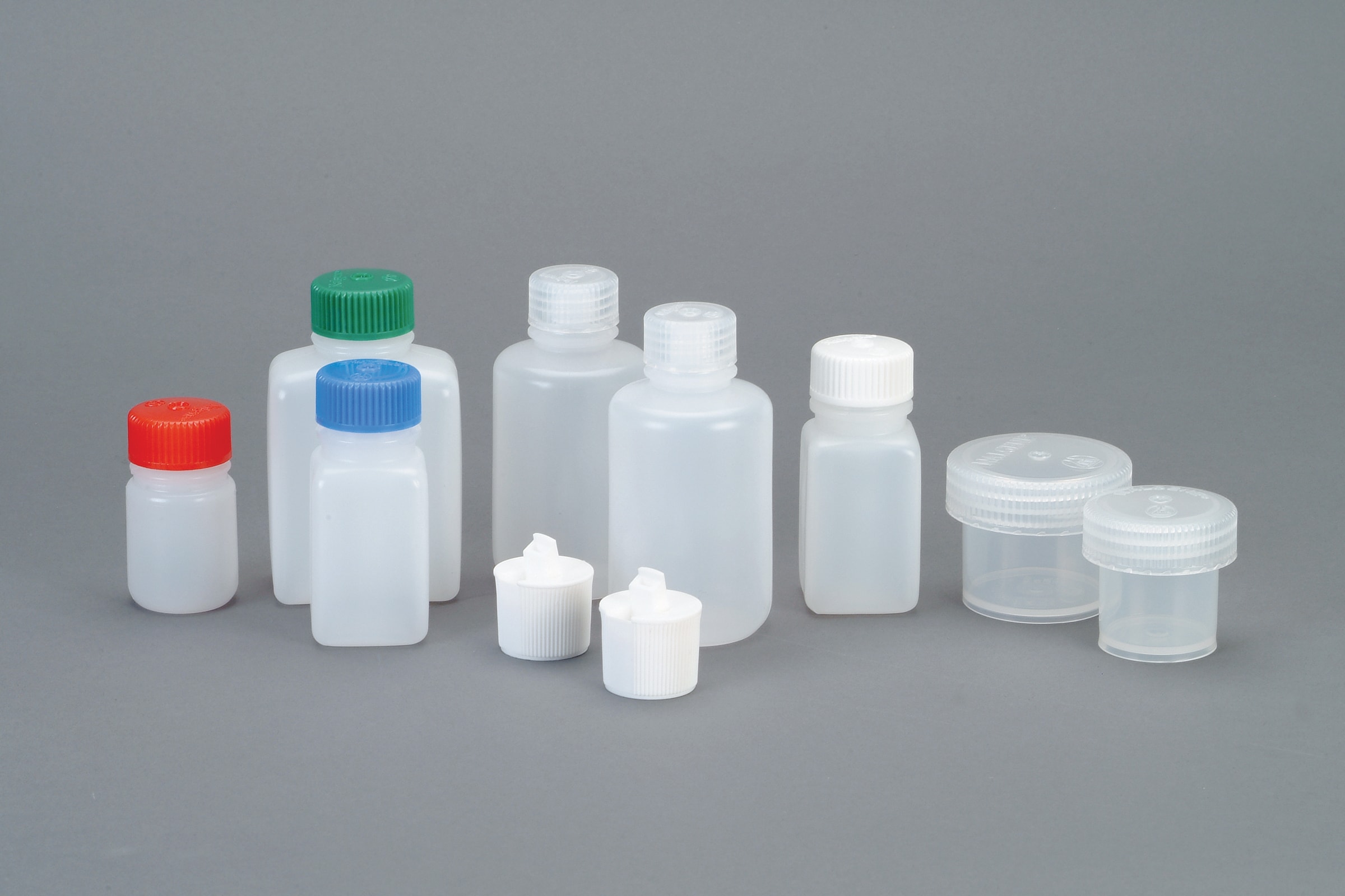 The Medium Travel Kit includes nine assorted plastic bottles with colored caps and two clear containers, displayed on a gray background.