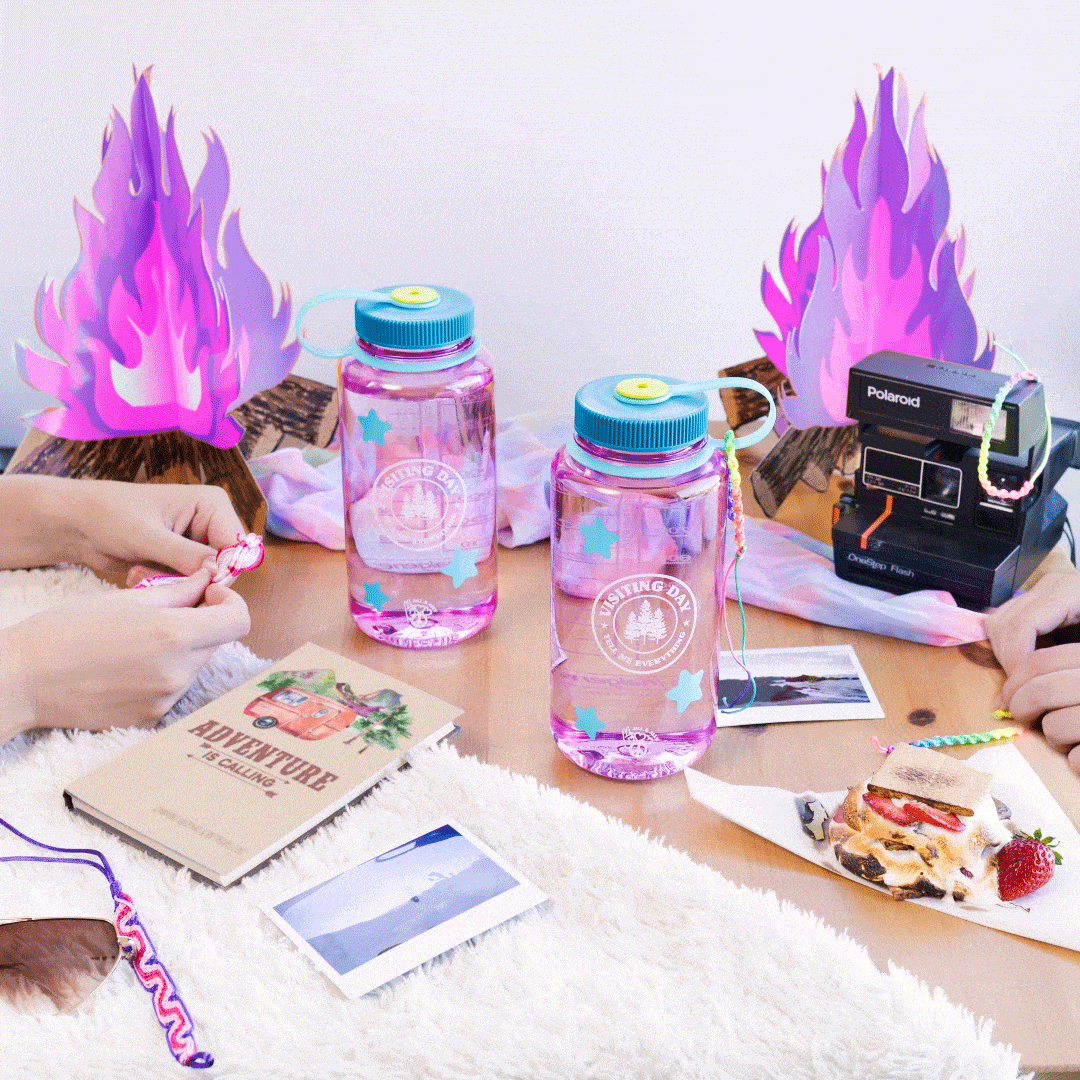 Two hands at a table with pink water bottles, snacks, photos, and cartoon purple flames in the background.