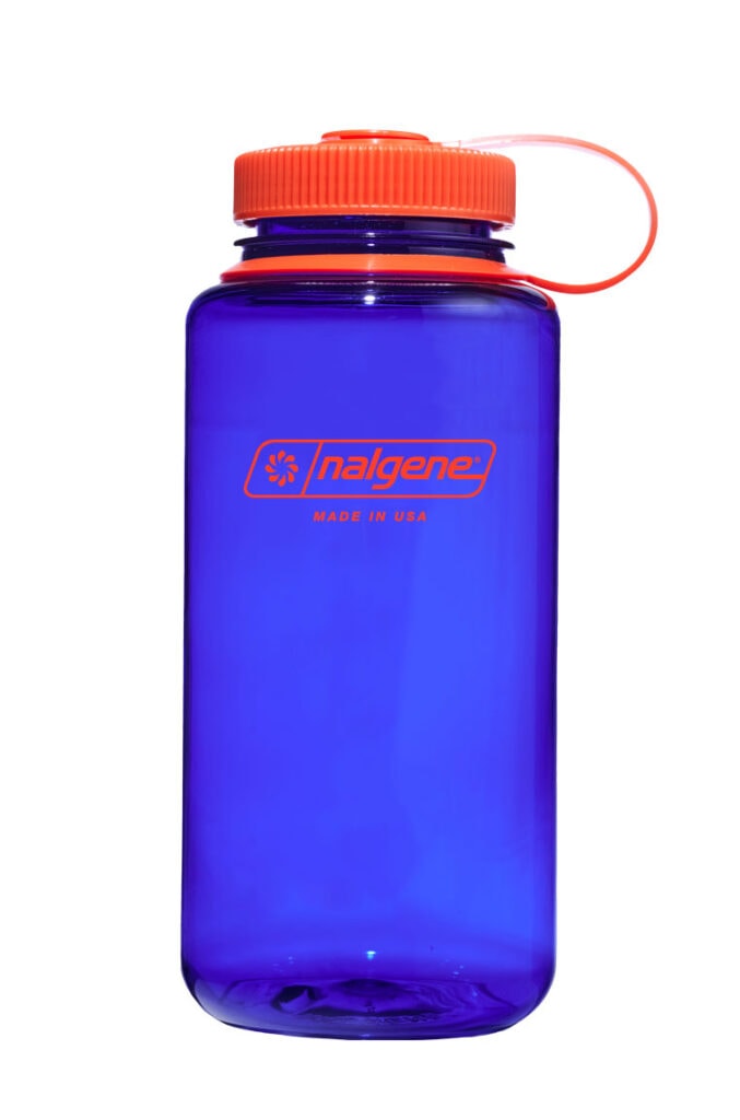 A blue Nalgene water bottle with an orange lid and logo, standing upright on a white background.