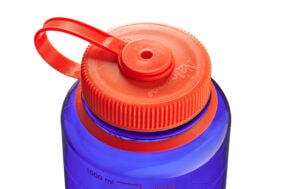 Close-up of a blue water bottle with an orange screw-on lid and a looped handle.