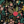 Floral pattern with colorful flowers and green leaves on a black background.