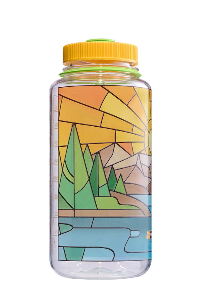 A clear water bottle with a colorful, geometric design of a landscape with trees, river, and sun.