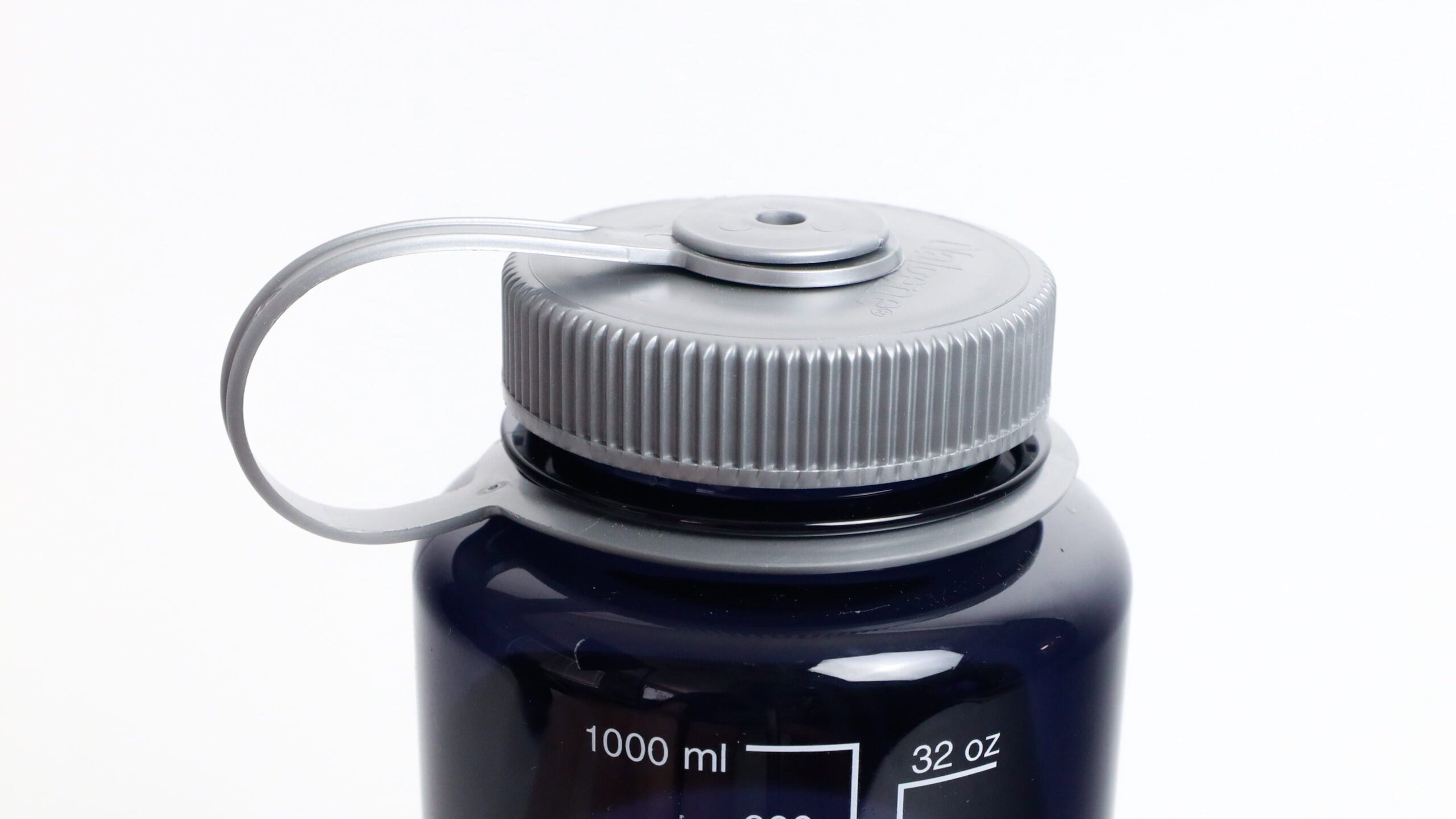 A close-up of the 32oz Wide Mouth Large Logo reusable water bottle with a gray screw cap and side measuring scale.
