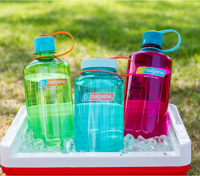 A red and white cooler with three water bottles in it.