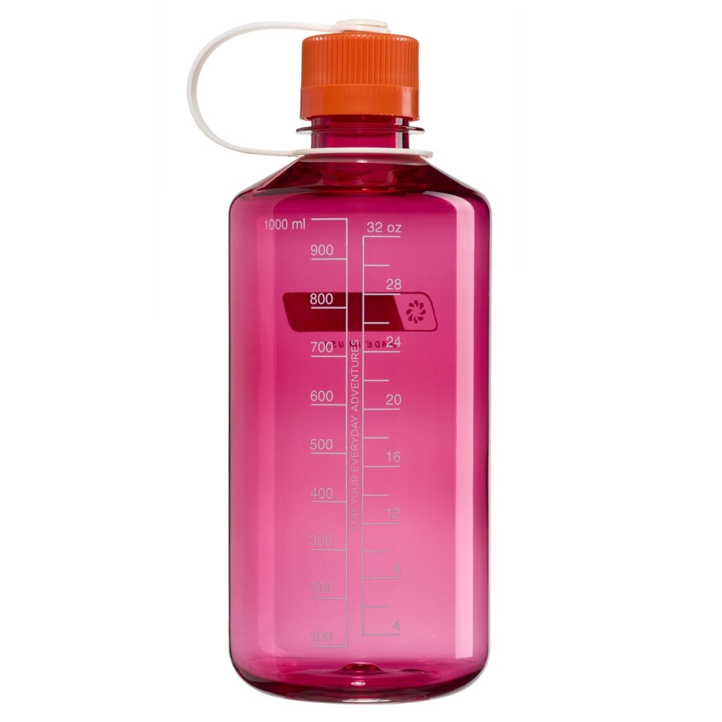 The 32oz NM Thrill in Motion is a translucent pink water bottle with a white measurement scale and an orange screw cap.